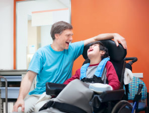 caregiver and little boy laughing