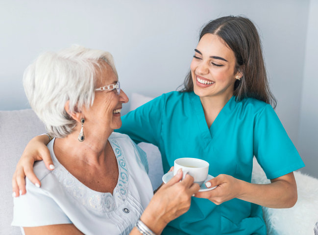 senior woman with caregiver smiling
